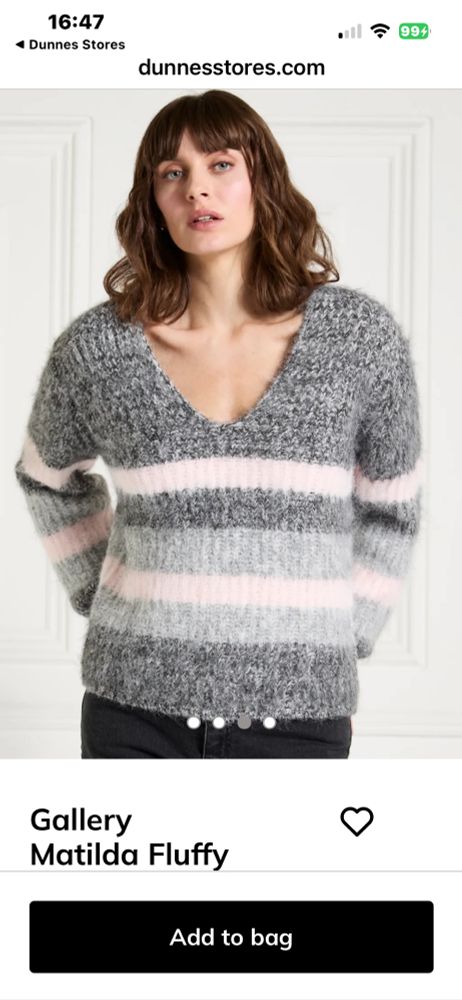 A model is wearing a v next mohair style jumper large striped blocks of pink and grey 