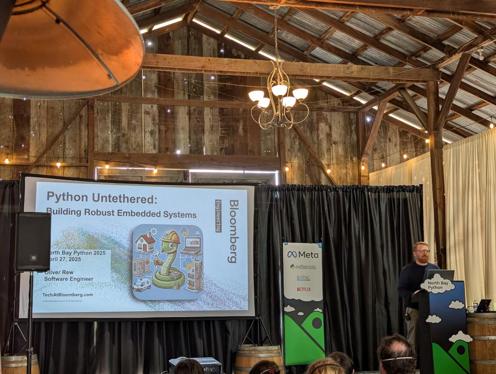A photo of Oliver on stage beginning his presentation.