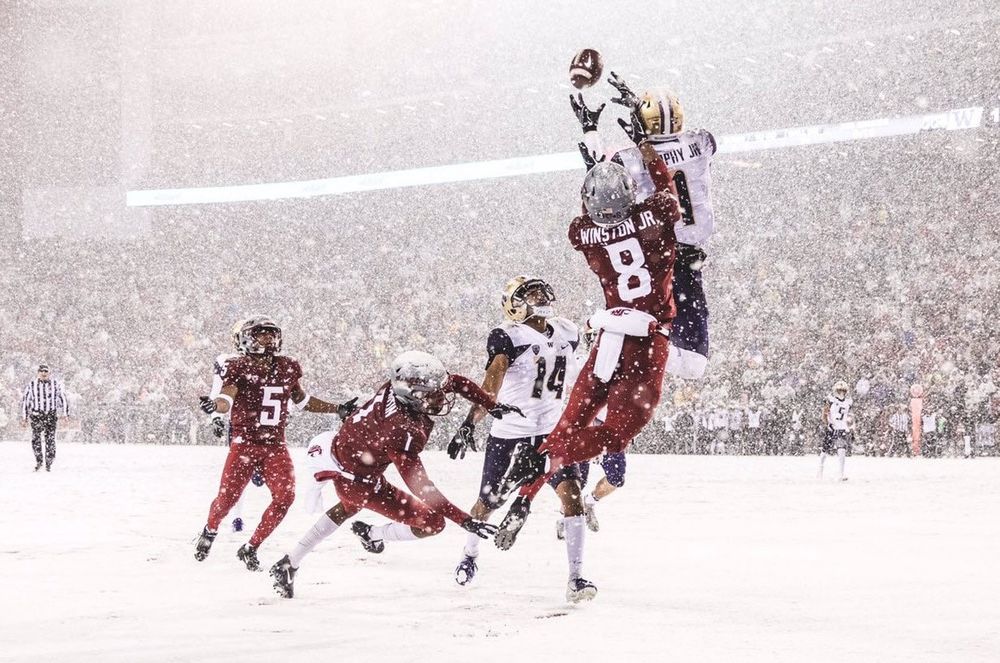 Washington Huskies CB Byron Murphy Jr. grabs an end-zone interception in the snow above the hands of WSU WR Easop Winston Jr. at the 2018 Apple Cup
