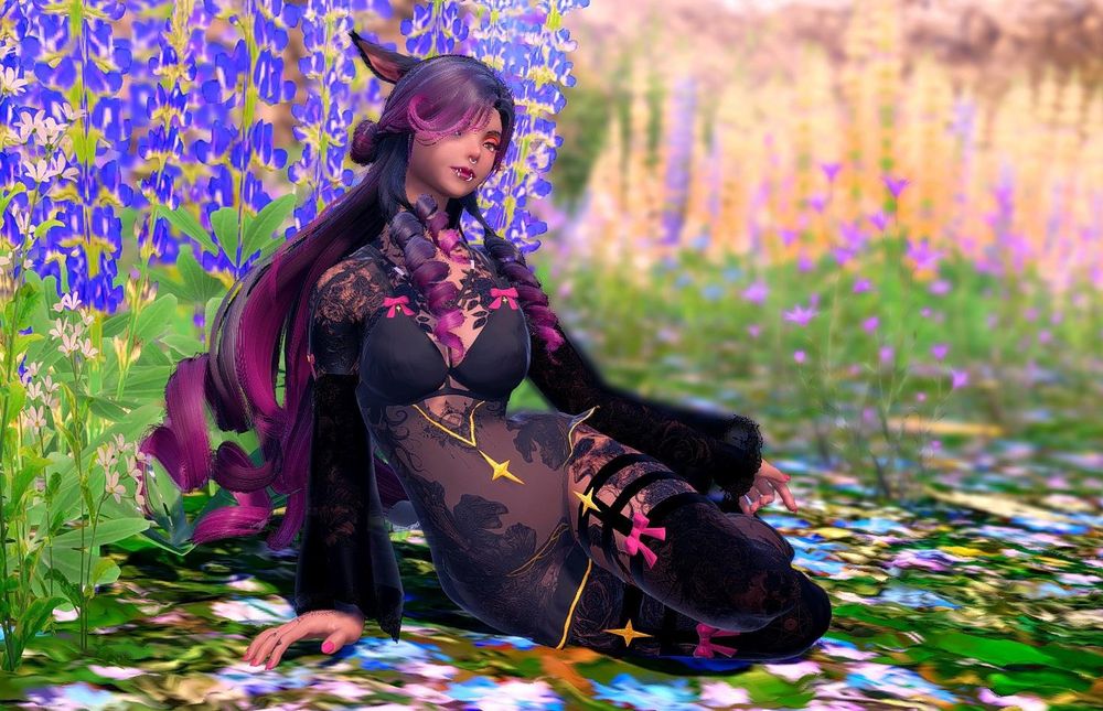 A miqote woman sits in a field of flowers.