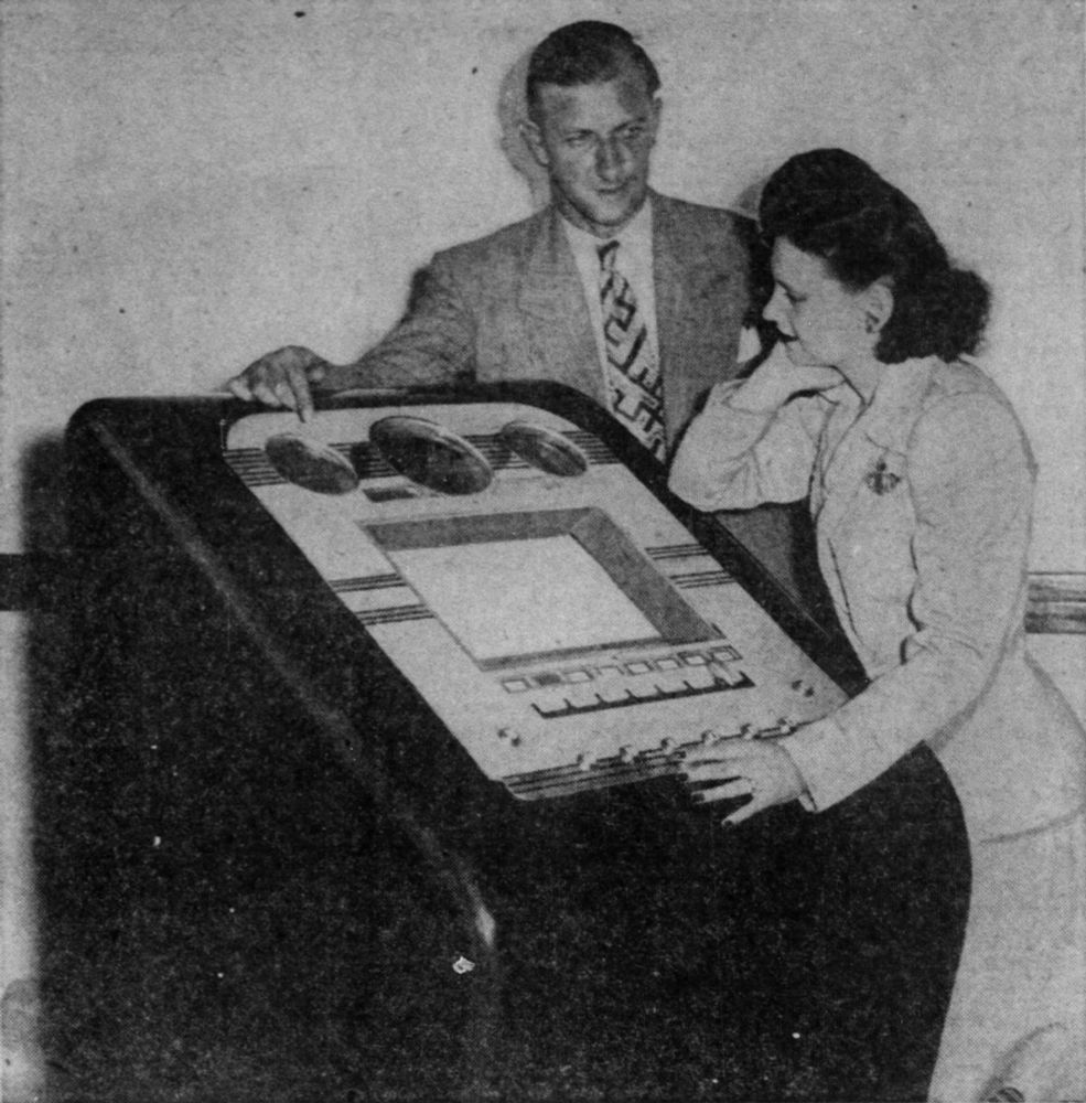 1945-09-02 Detroit Free Press pg Part 2 3. Thomas Sisson demonstrates the newly redesigned quiz device to a woman.