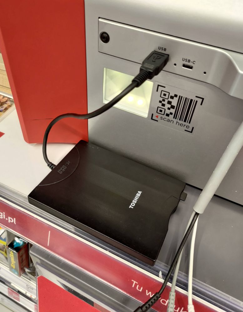 Toshiba USB floppy drive connected to a photo printing machine at Rossmann
