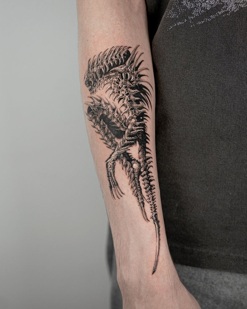 a tattoo of the xenomorph alien on arm by yujhi