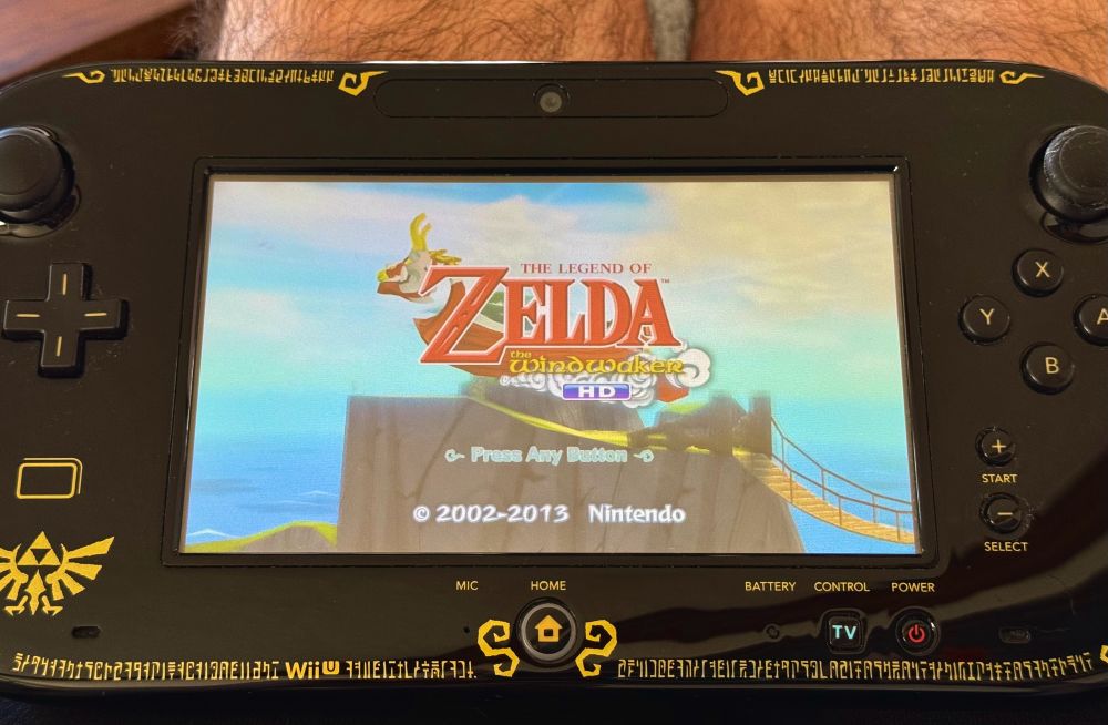 A pic of a WiiU tablet with the game Zelda the wind Waker HD title screen
