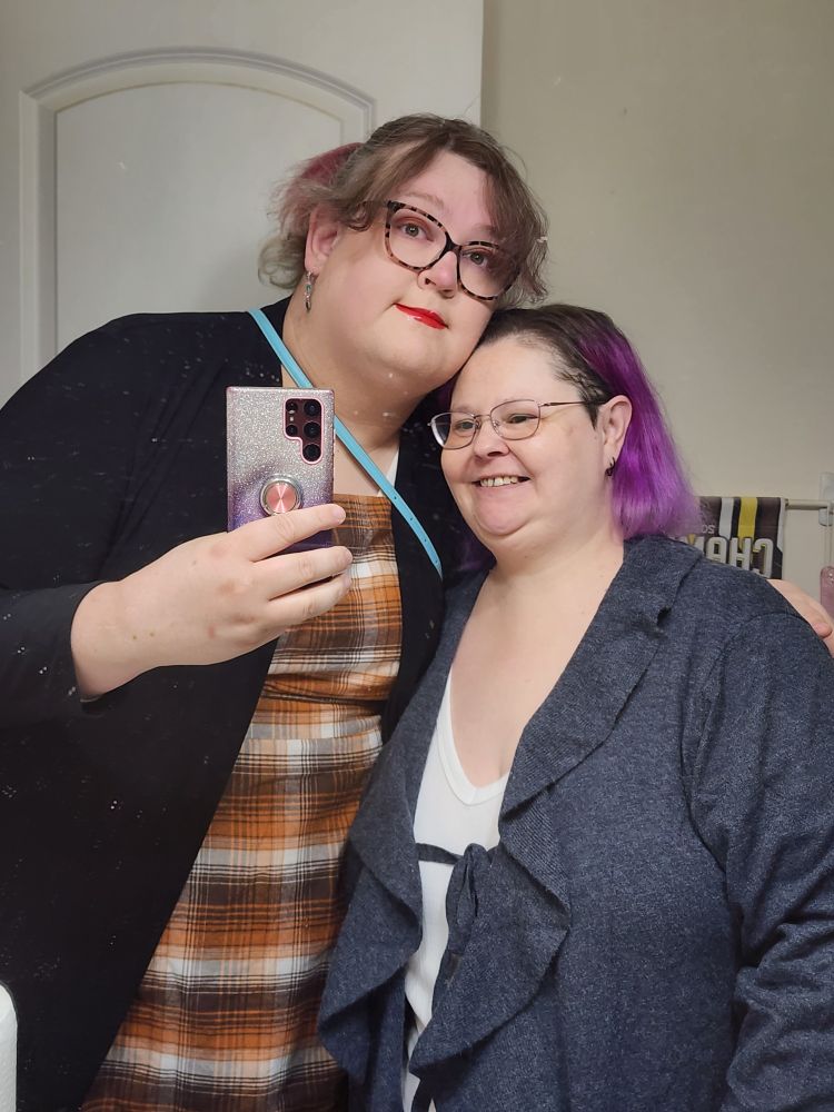 Maddie (left) in orange plaid and me (right) in a white shirt and a smokey blue cardigan.