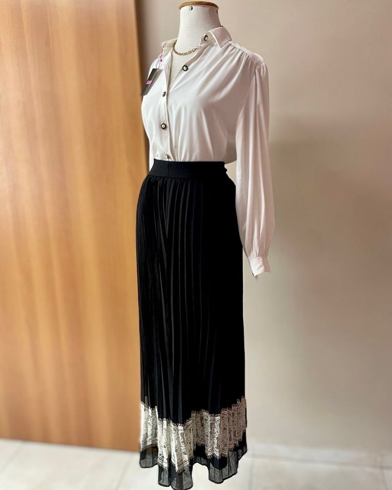 Foto de anúncio de uma
Camisa Vintage Branca
Saia Plissada preta com detalhes em renda branco