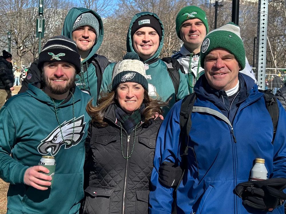 family standing along the philadelphia eagles 2025 parade route on the ben franklin parkway. top row kyle smith, zack smith, matthew smith. bottom row dan smith, jeanne smith, ed smith