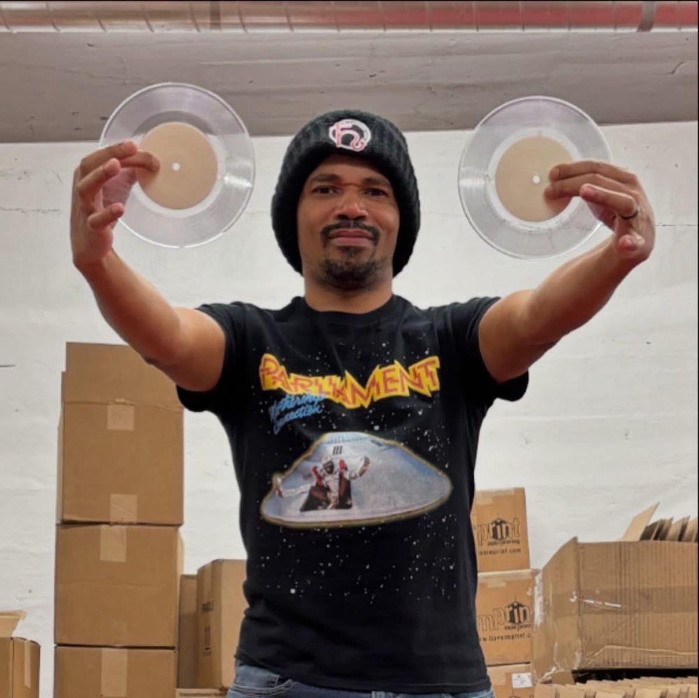 Buscrates holding up clear 7" test presses at Hellbender Vinyl