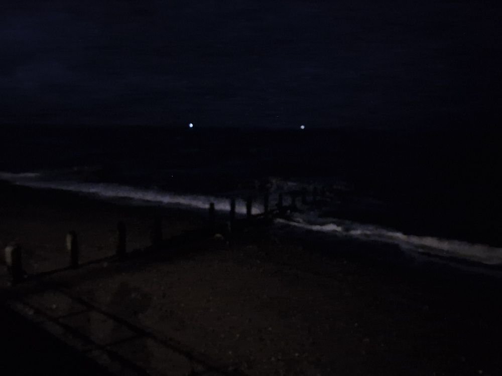 View of the sea in Teignmouth in the dark. 