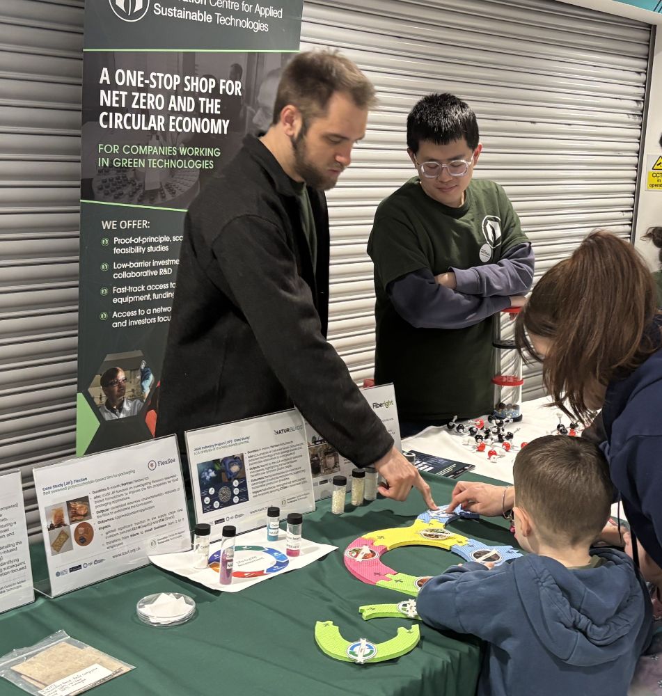 Dr Jon Husband talks to a parent and child about the carbon emission game.