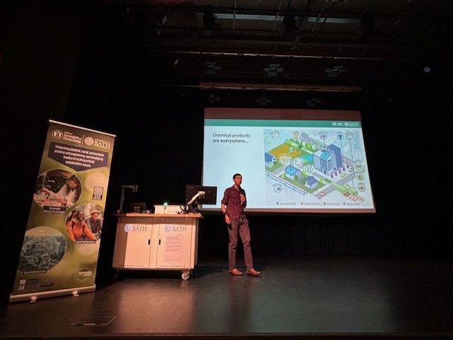 Dr Rick Lupton presents at the Summer Showcase in front of a PPT.