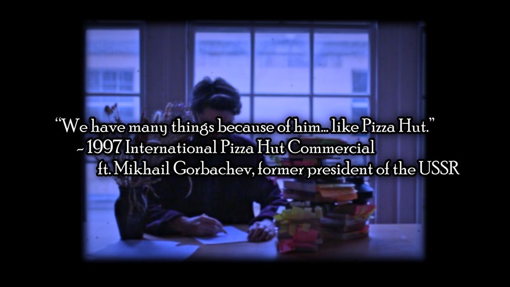 Spice sits at a desk in a faded edged frame. "We have many things because of him... like Pizza Hut." is written infront of it, attributed to a 1997 International Pizza Hut Commercial ft. Mikhail Gorbachev.