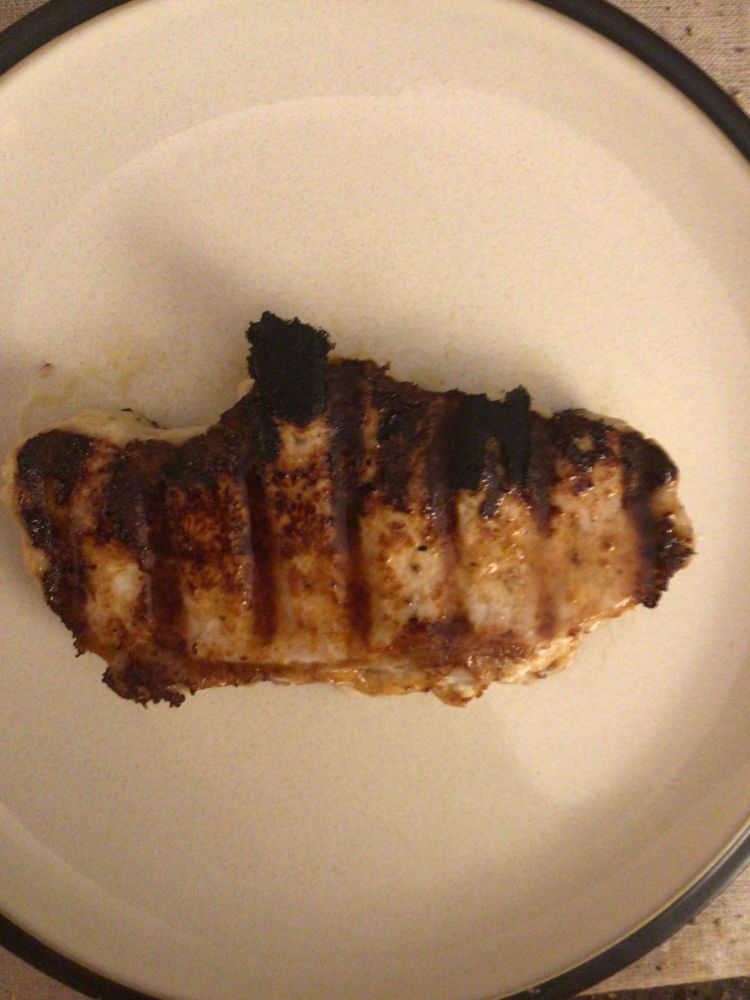 A horseradish peppercorn grilled pork chop on a dinner plate