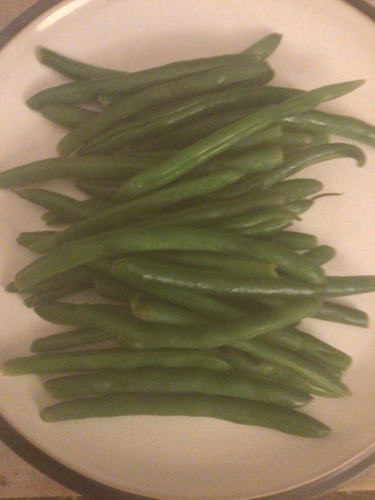 A generous portion of green beans on a dinner plate