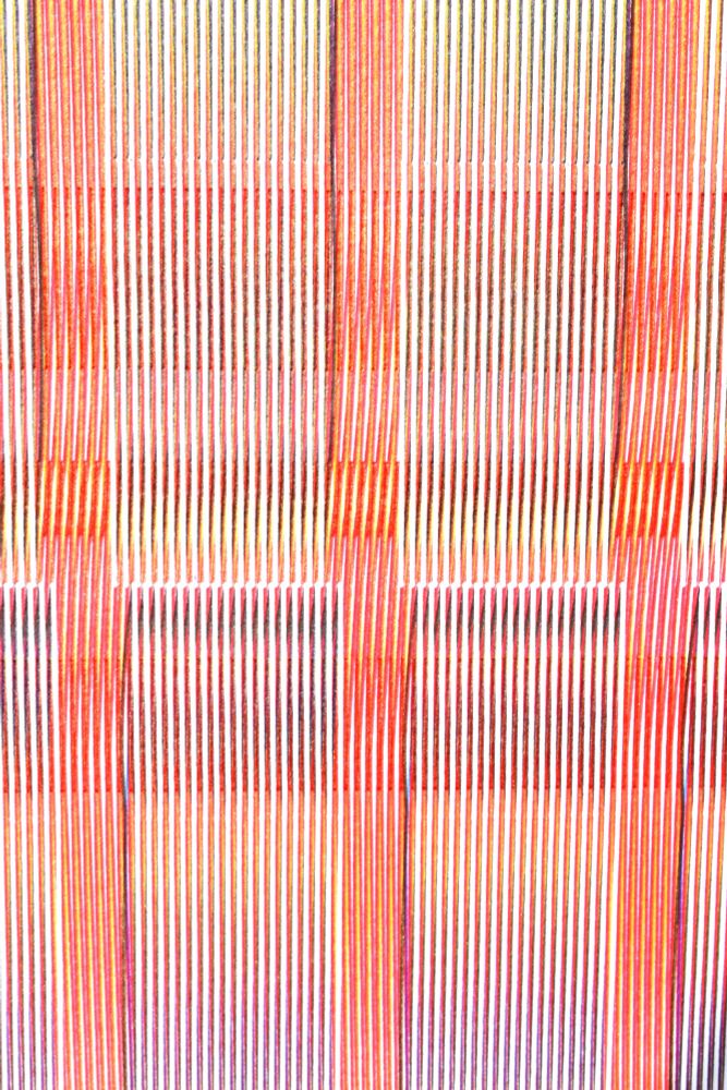 Detail of abstract pen plotted print made with overlapping lines.  Mostly red with a top layer of white.
