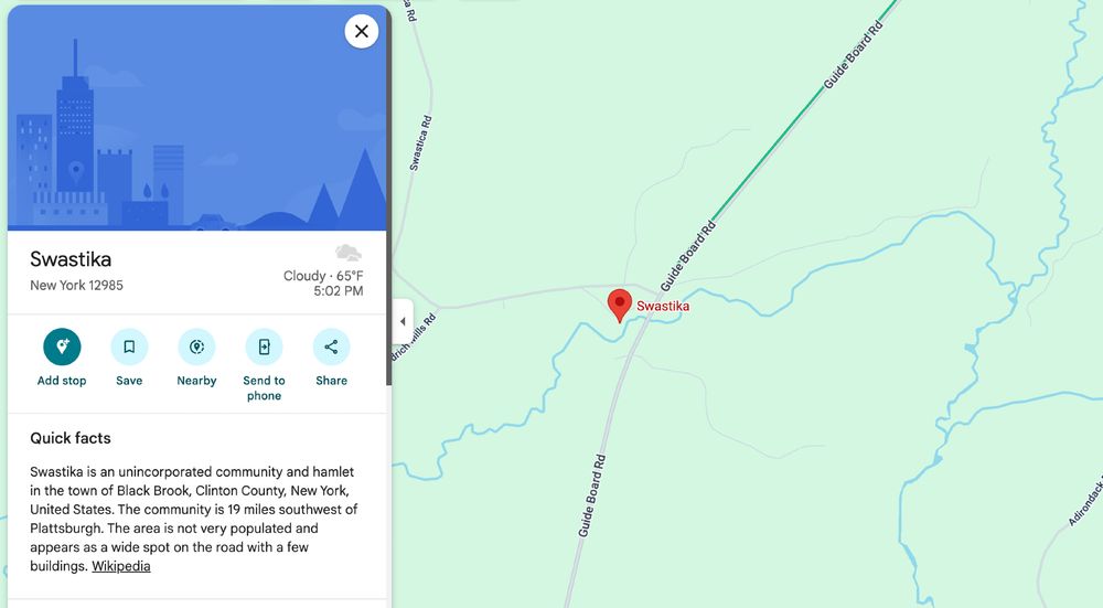 Screenshot of the small town of "Swastika, NY" on a map. Text reads: "Swastika is an unincorporated community and hamlet in the town of Black Brook, Clinton County, New York, United States. The community is 19 miles southwest of Plattsburgh. The area is not very populated and appears as a wide spot on the road with a few buildings."