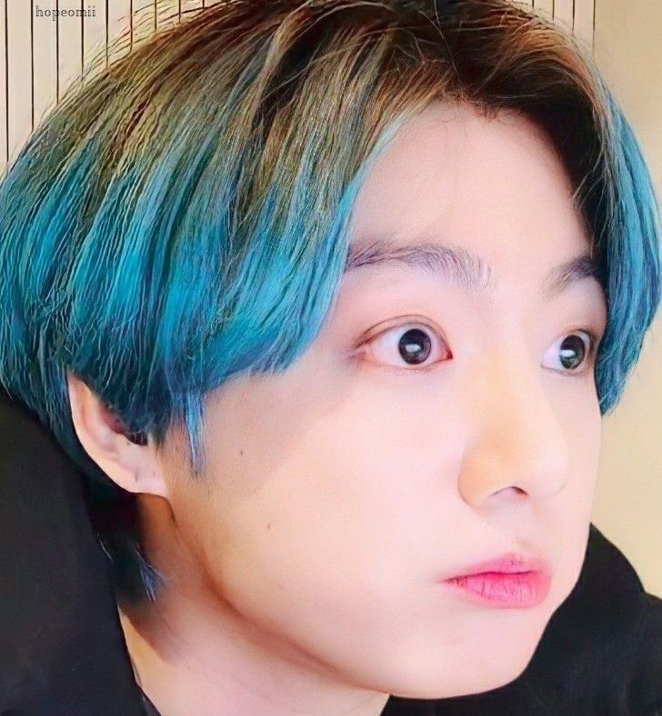 Blue haired Jungkook. His eyes are wide and he's pouting slightly.