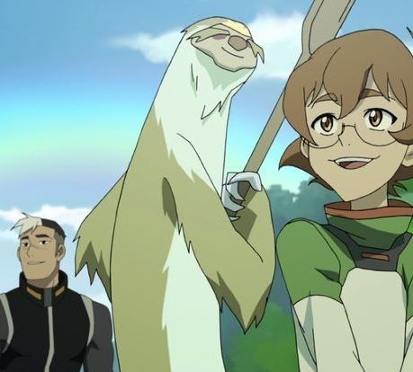 Tall, slim, sloth-like alien. It has brown and white fur, big claws, bushy eyebrows, a big round nose and a friendly smile. It's holding a canoe paddle as they float down a river. It's accompanied by two other VLD characters: Pidge on the right and Shiro on the left. They are happy and smiling.