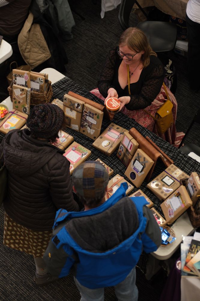Patrons interact with a vendor at A2 Community Bookfest!