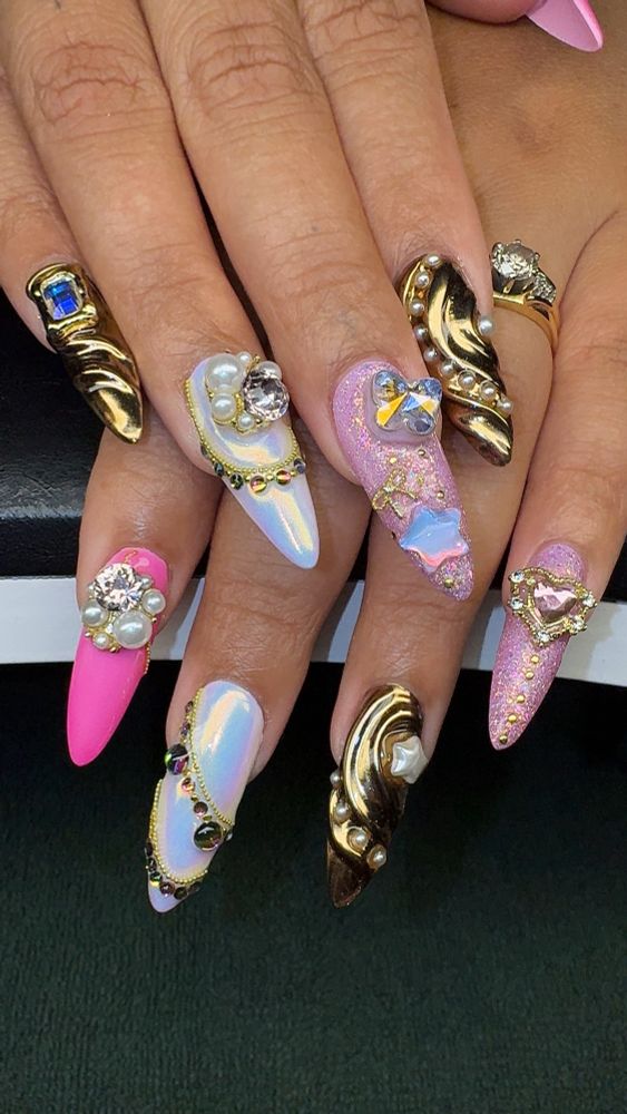 a long almond shaped manicure with gold accents and chunky pearl and star charms 
