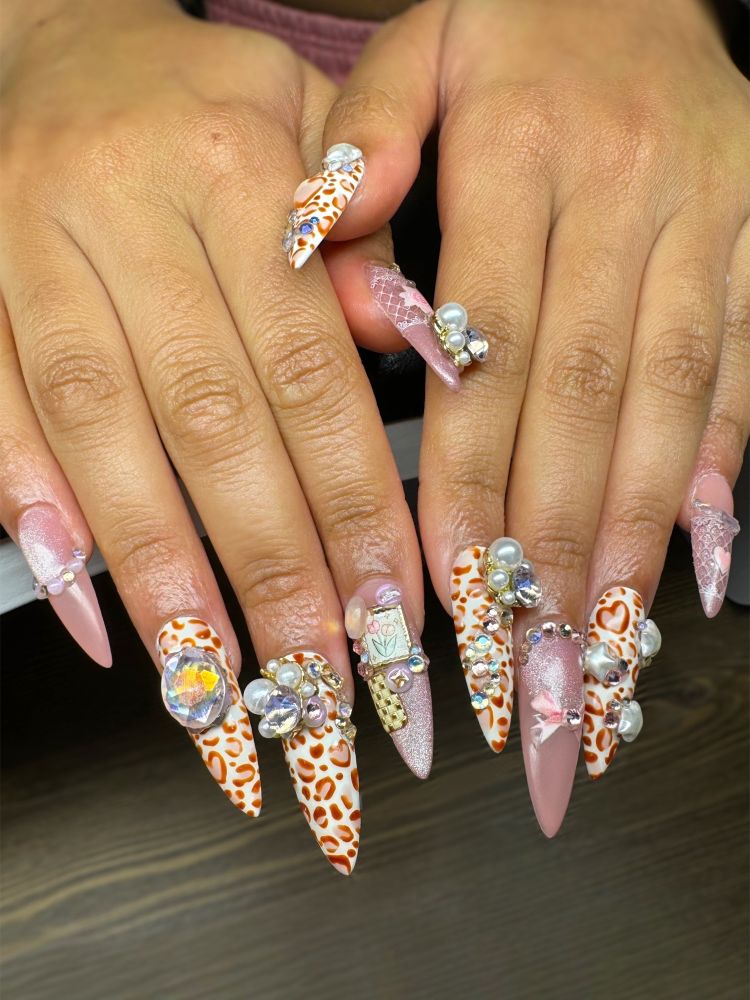 a leopard and pink rhinestone long stiletto shaped manicure 
