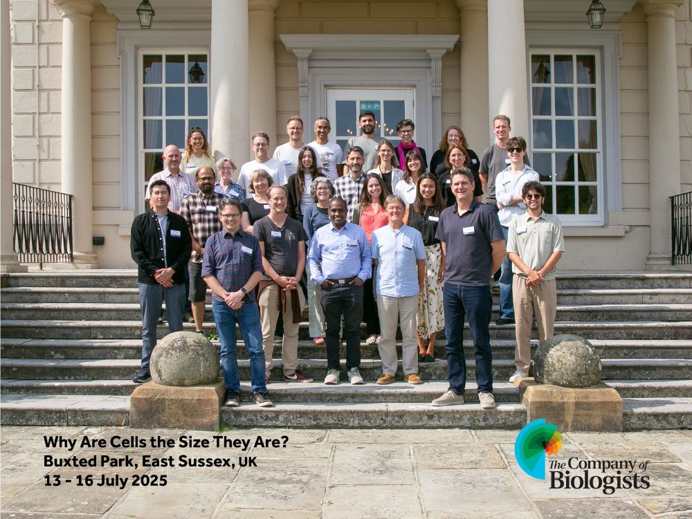 Workshop attendees standing on the steps in front of the event venue. The individuals are dressed in casual to semi-formal attire.

Image text: Why Are Cells the Size They Are?
Buxted Park, East Sussex, UK
13-16 July 2025