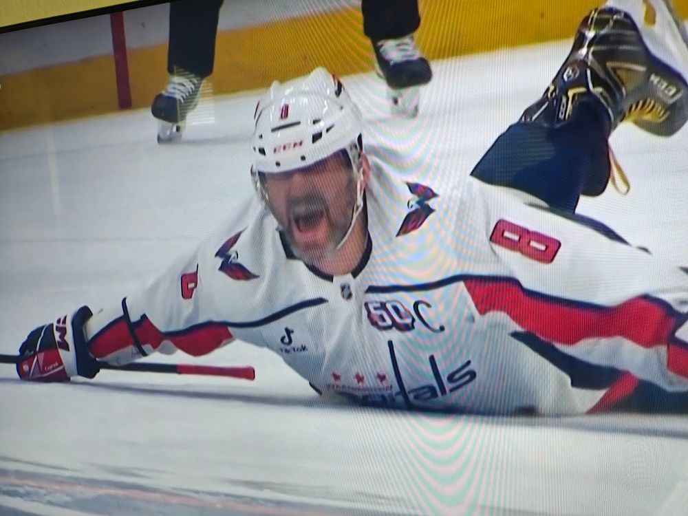 Alex Ovechkin belly flops on the ice after scoring goal 895.