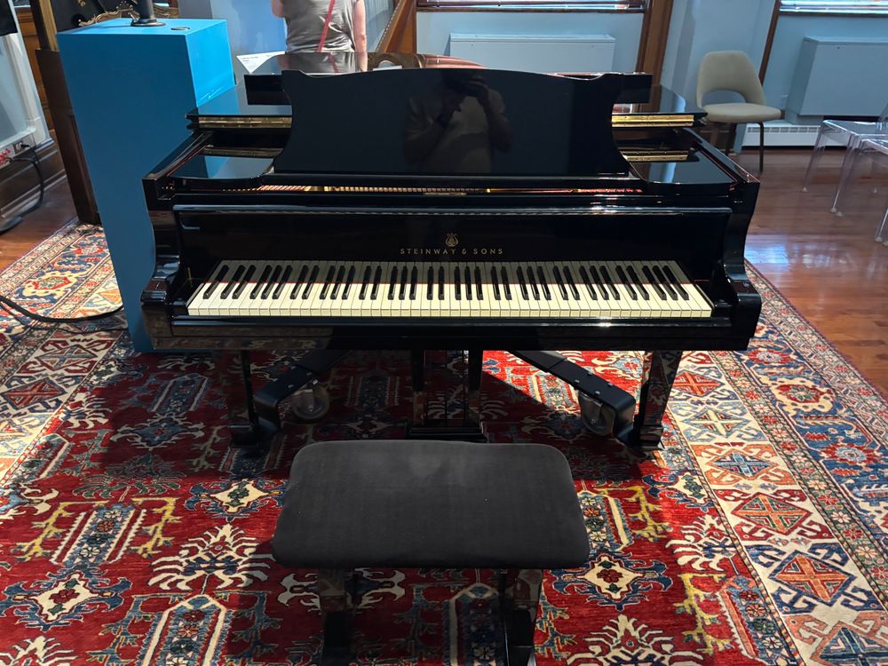 It’s a grand piano. On a rug. Doesn’t look like much
