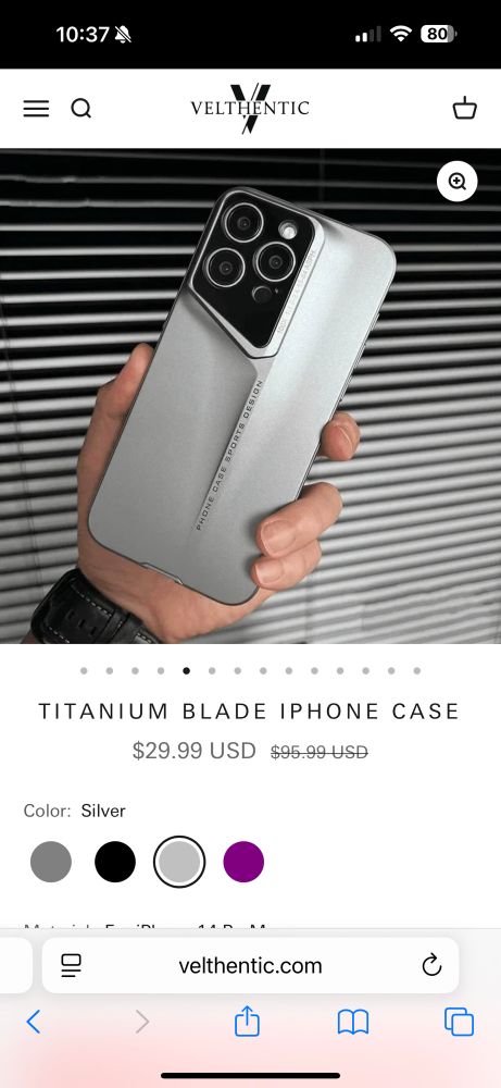 Screenshot of a “titanium blade iPhone case, disappointingly with no sharp edges or points. iPhone is either 6”x12”, or the hand model is no older than four. 