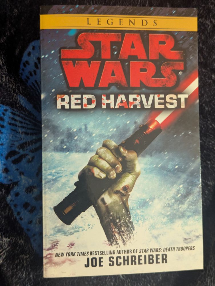 Star Wars Legends Red Harvest by Joe Schreiber 

Picture of a Zombie hand holding a red lightsaber bursting out of the snow.