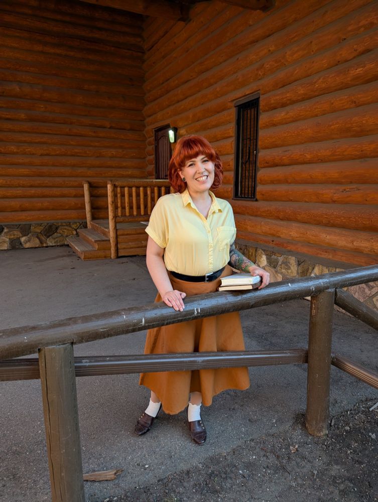 Gaia as Penny from Stardew Valley by a log cabin 