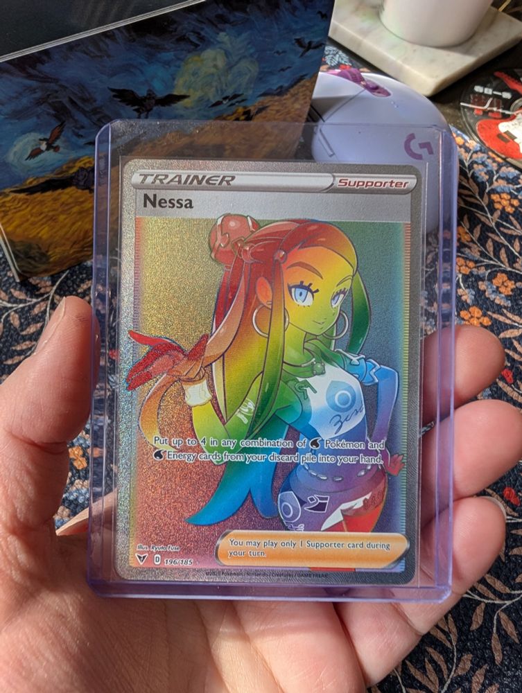 Nessa rainbow foil pokemon card in Rose's hand