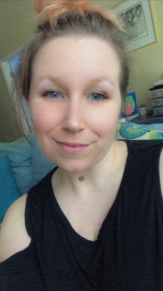 Selfie of Mindy smiling at camera with black top