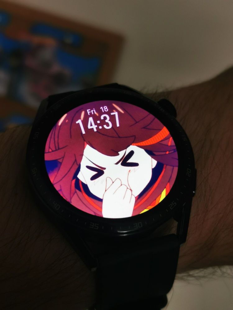 Photo of a smartwatch being worn on a wrist. The screen is lit up with a screen capture of Ryuko Matoi from the anime Kill La Kill 