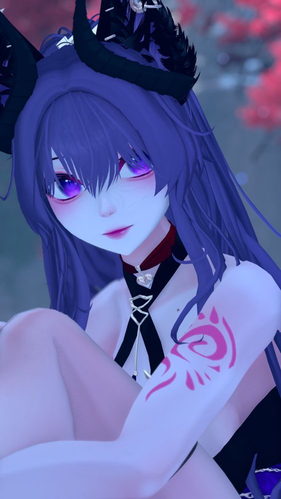 Kitsune succubus model posed sitting down with her knees to her chest 