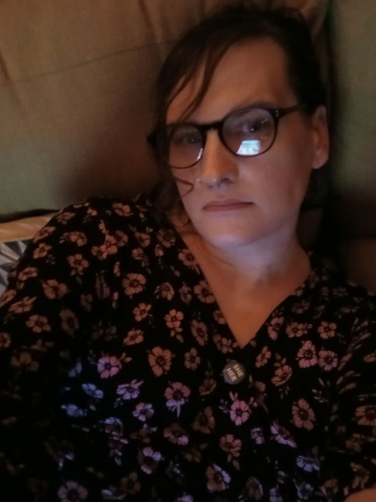 Me lying on a sofa in my pretty dress.