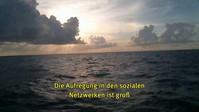 Webcam-Foto vom Meer, untertitelt mit gelber Schrift: "Die Aufregung in den sozialen Netzwerken ist groß"
