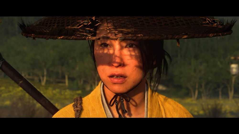 a closeup of atsu from ghost of yōtei. she wears a wide brimmed hat that is tied under her chin. her sword is on her back.