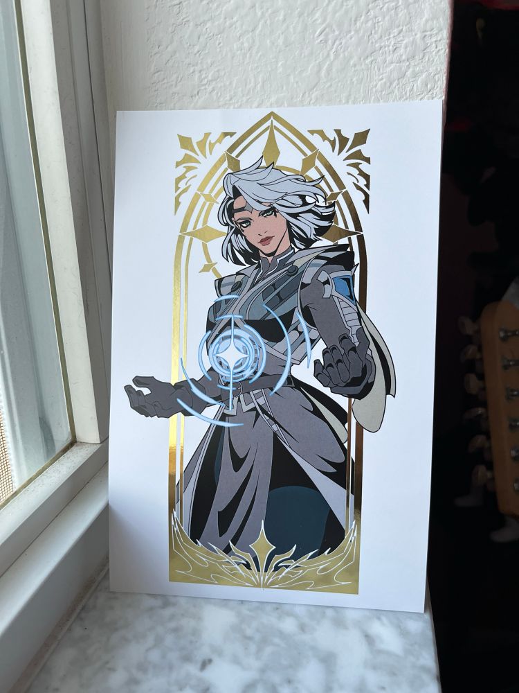 art of isobel thorm from baldur’s gate 3. she is framed in gold foil.