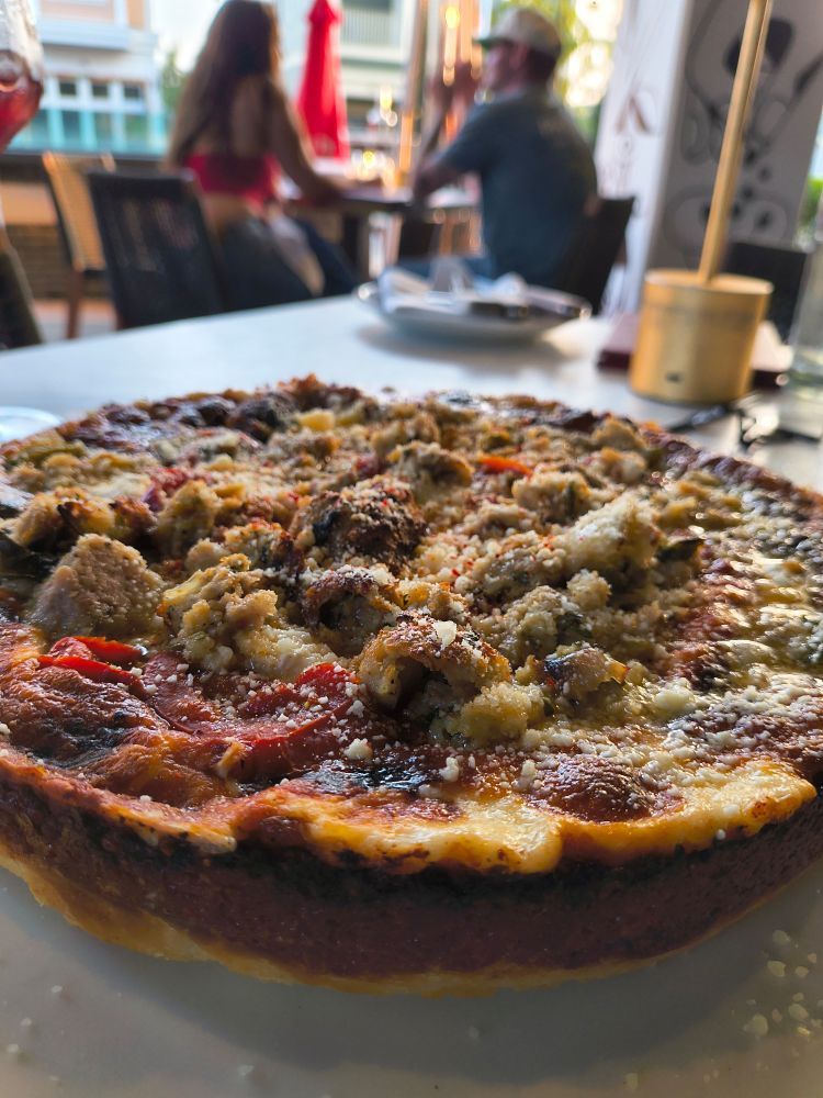 A deep dish pizza made with ricotta and meatballs.