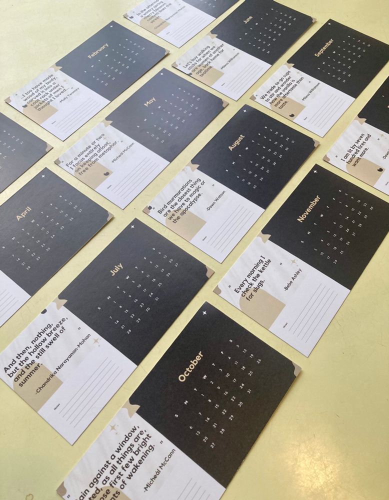 A photograph of a cascade of a notecard calendar. Each month has a short quote from a poet on it.