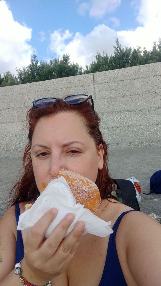 ME, eating a ciambella on the beach