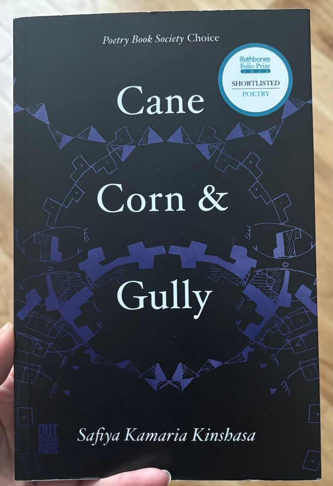Cane Corn & Gully by Safiya Kamaria Kinshasa. The black cover has swirled sections of purple labanotation 
