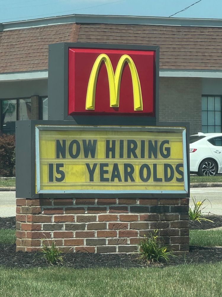 A sign at McDonald’s that appears to read, “Now hiring 15 yearolds”