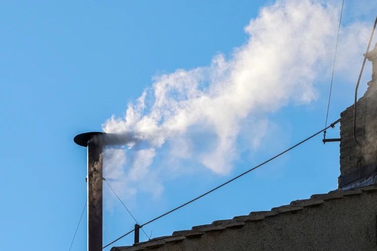 White smoke coming from the chimney of the Sistine Chapel