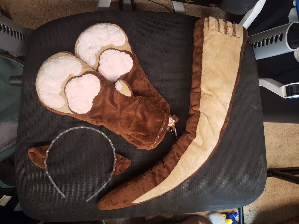 A pair of paws, an otter tail, and an otter ear headband