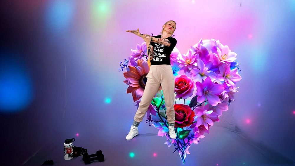 Emilia stretches against a purple background of flowers in the shape of a heart