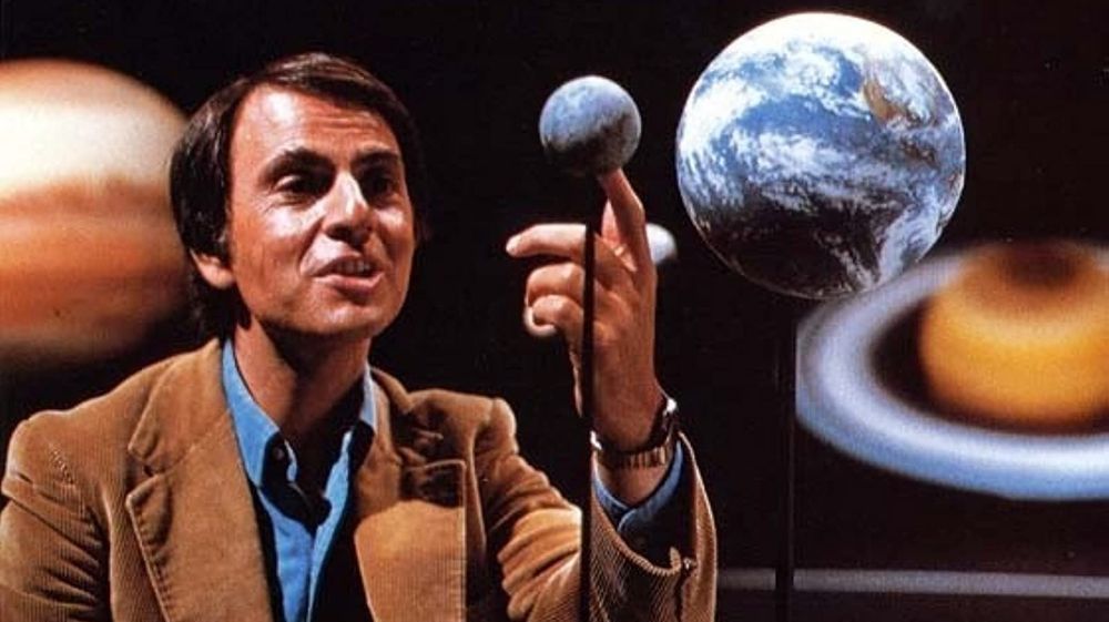 Carl Sagan pointing to a planet