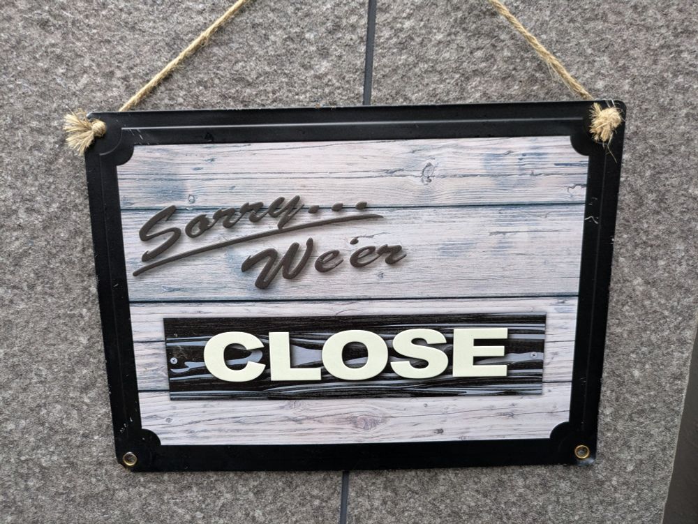 A sign that says 

"Sorry... We'er CLOSE"