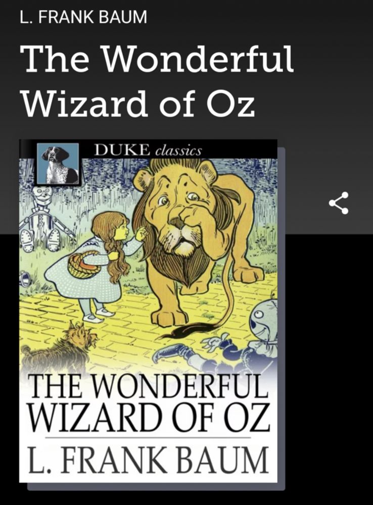 a screenshot of the cover of The Wonderful Wizard of Oz, by L. Frank Baum, taken within the Libby app. The cover is an old fashioned illustration showing a little girl comforting an anxious looking lion